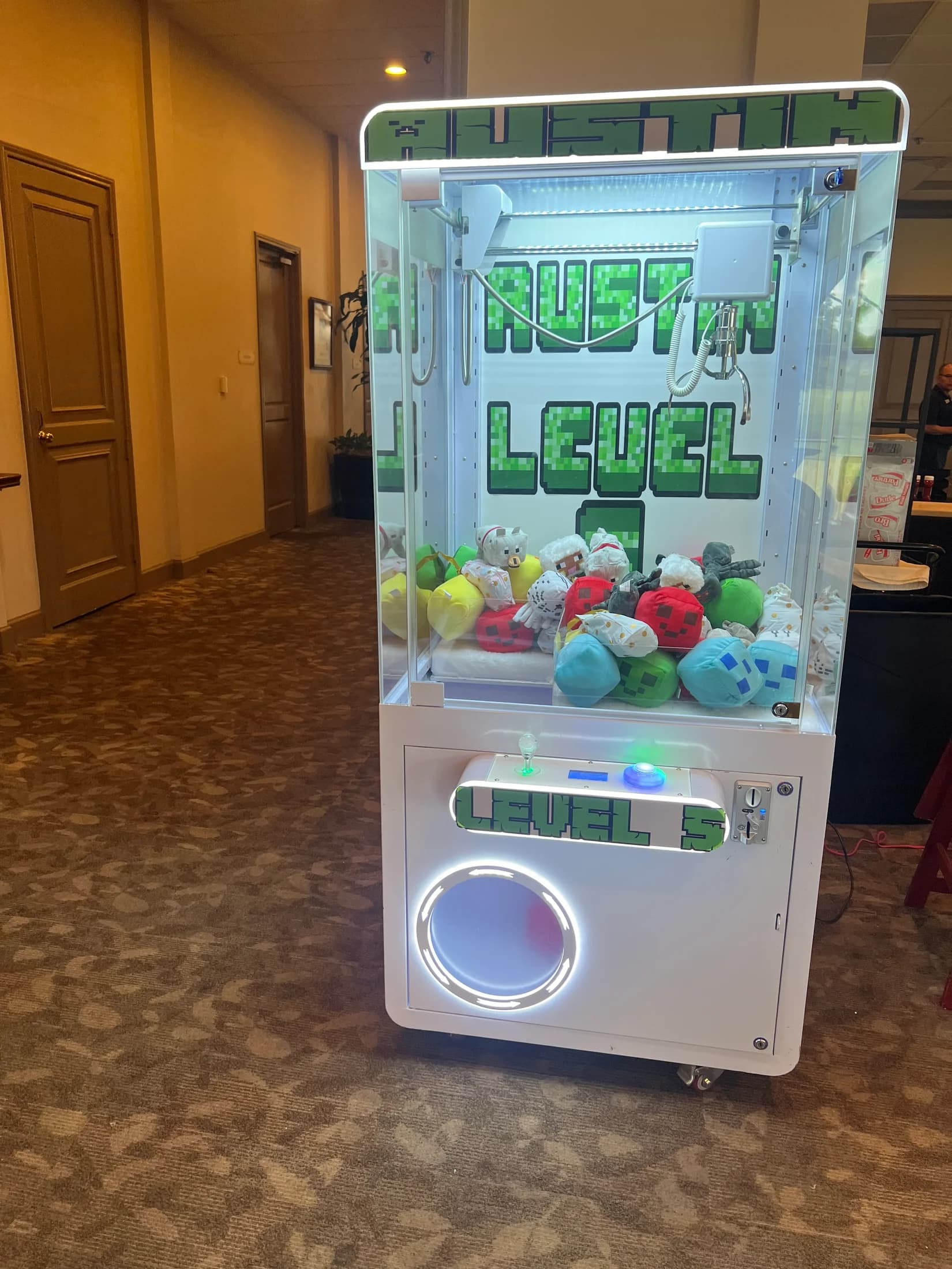 Rusty Reel branded claw machine filled with plush prizes