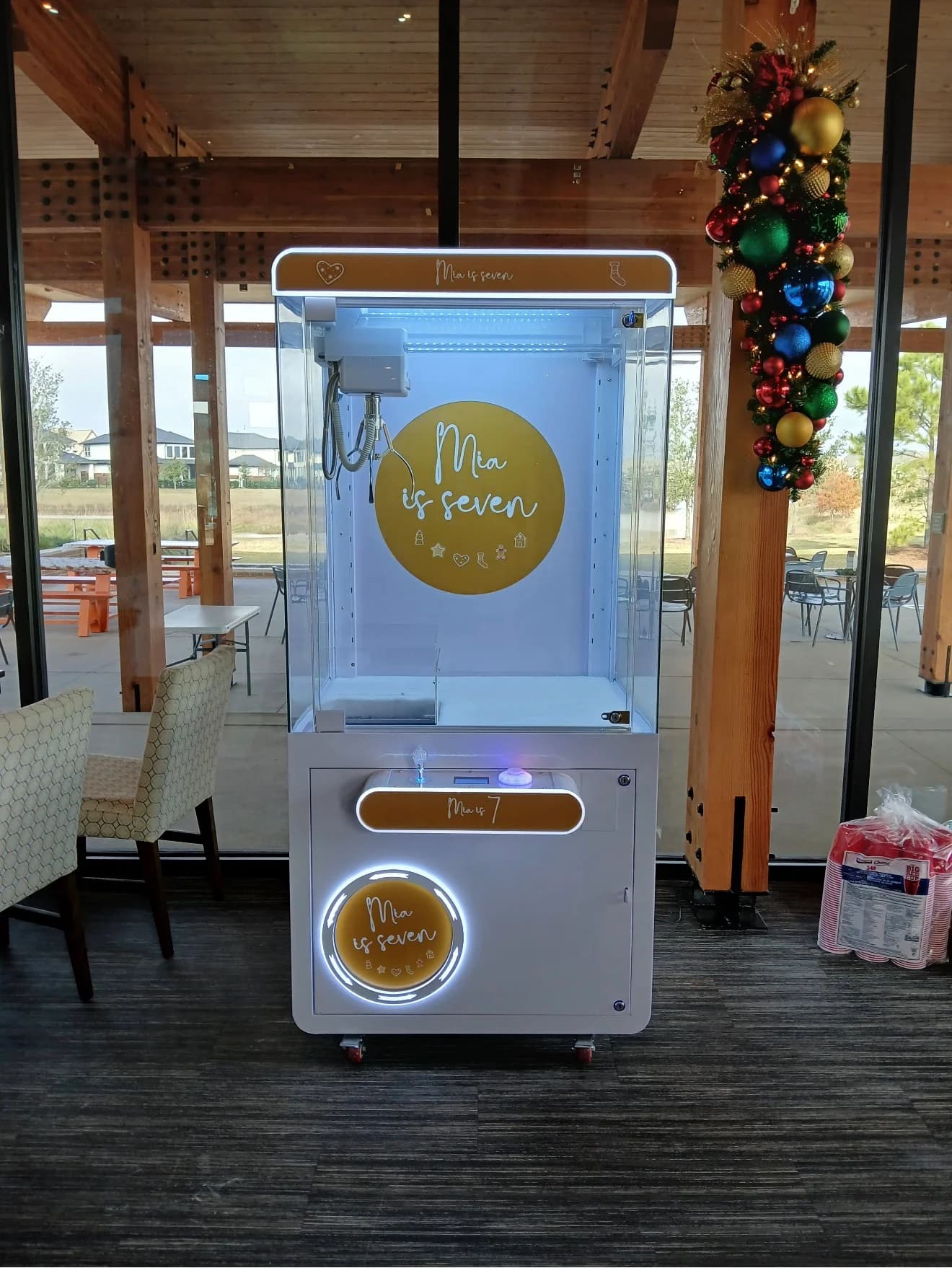 The Festive branded claw machine at a venue