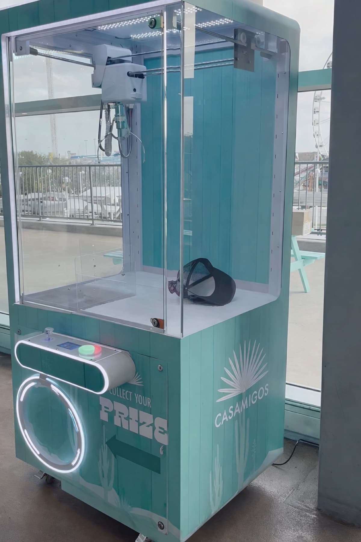 Custom turquoise Casamigos claw machine at an outdoor event