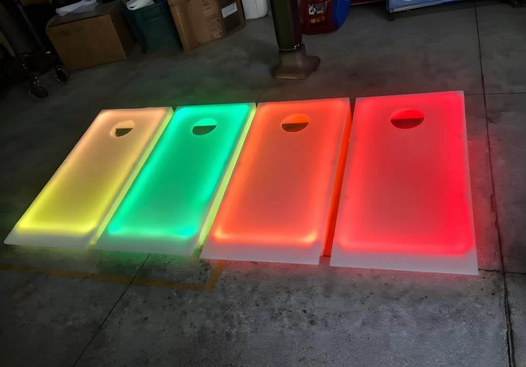 LED cornhole set glowing at a Houston corporate event